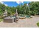 A stunning backyard pool and hot tub with surrounding lounge area and lush greenery, perfect for relaxation at 1391 Harris Rd, Lawrenceville, GA 30043