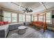Cozy sunroom with swing, large windows, neutral decor, and a ceiling fan at 1391 Harris Rd, Lawrenceville, GA 30043