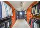 Spacious walk-in closet featuring custom wood shelving and drawers for ample storage at 1391 Harris Rd, Lawrenceville, GA 30043