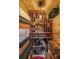 A home wine cellar with rows of stacked wine bottles and boxes at 1391 Harris Rd, Lawrenceville, GA 30043