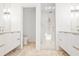 Luxurious bathroom with double vanities, a glass-enclosed shower, and modern fixtures at 1718 Barnesdale Ne Way, Atlanta, GA 30309