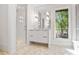 Stylish bathroom features a shower, vanity, large mirror, and views of the outdoors at 1718 Barnesdale Ne Way, Atlanta, GA 30309