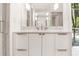 Close-up of a luxurious bathroom with designer vanity, fixtures, and a sunlit view at 1718 Barnesdale Ne Way, Atlanta, GA 30309