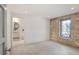 Bedroom featuring a stone accent wall and an en suite bathroom at 1718 Barnesdale Ne Way, Atlanta, GA 30309