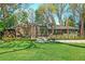 Charming home boasts a manicured lawn, lush landscaping, and a striking modern design with large windows at 1718 Barnesdale Ne Way, Atlanta, GA 30309
