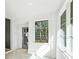 Bright hallway features tiled floor and windows with picturesque wooded views at 1718 Barnesdale Ne Way, Atlanta, GA 30309