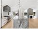 Modern kitchen with an island, stainless steel oven, and sleek white cabinetry with black hardware at 1718 Barnesdale Ne Way, Atlanta, GA 30309