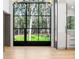 Modern kitchen featuring a large window overlooking the backyard, white cabinets, and hardwood floors at 1718 Barnesdale Ne Way, Atlanta, GA 30309