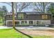 Beautiful modern home showcases a two-story design with a stone foundation, a rear lawn, and mature landscaping at 1718 Barnesdale Ne Way, Atlanta, GA 30309