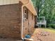 Brick exterior with a wooden deck and tree covered backyard at 213 Sharon Drive, Canton, GA 30115