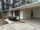 Inviting home with brick, white siding, and a convenient carport nestled in a treed yard at 213 Sharon Drive, Canton, GA 30115