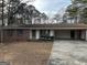 Inviting home with brick, white siding, and a convenient carport nestled in a treed yard at 213 Sharon Drive, Canton, GA 30115