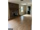 Inviting living room with a brick fireplace, wood flooring, and an open layout at 213 Sharon Drive, Canton, GA 30115