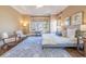 Bright bedroom boasts large windows, neutral paint colors, hardwood flooring, and stylish furniture at 4022 Newhaven Ne Cir, Brookhaven, GA 30319