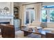 This elegant living room features a fireplace, built-in shelving, and French doors leading to a balcony at 4022 Newhaven Ne Cir, Brookhaven, GA 30319