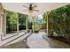 Covered backyard patio with stone flooring and a ceiling fan at 4022 Newhaven Ne Cir, Brookhaven, GA 30319