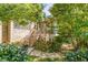 Backyard with a wooden deck surrounded by lush landscaping and natural stone steps at 4022 Newhaven Ne Cir, Brookhaven, GA 30319