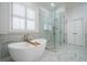 Elegant bathroom featuring soaking tub, glass shower, and natural light at 4022 Newhaven Ne Cir, Brookhaven, GA 30319
