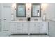 Double sink bathroom vanity with white cabinetry and marble countertops at 4022 Newhaven Ne Cir, Brookhaven, GA 30319