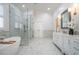 Luxurious bathroom featuring marble floors, soaking tub, and glass shower at 4022 Newhaven Ne Cir, Brookhaven, GA 30319