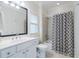 Well-lit bathroom featuring a vanity, toilet, and a shower/tub with a patterned curtain at 4022 Newhaven Ne Cir, Brookhaven, GA 30319