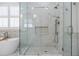 Modern bathroom featuring a glass shower with stone tile floor and marble walls, and a free-standing bathtub at 4022 Newhaven Ne Cir, Brookhaven, GA 30319