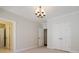 Empty bedroom featuring neutral carpet, crown molding, doors and a chandelier at 4022 Newhaven Ne Cir, Brookhaven, GA 30319