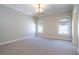 Empty bedroom featuring neutral carpet, crown molding, and two windows with shades at 4022 Newhaven Ne Cir, Brookhaven, GA 30319