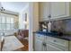 Elegant transition from kitchen to sitting room with custom cabinetry and countertops at 4022 Newhaven Ne Cir, Brookhaven, GA 30319