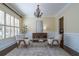 Living room boasts neutral paint, wainscoting, and plantation shutters at 4022 Newhaven Ne Cir, Brookhaven, GA 30319