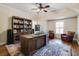 Spacious office featuring a large desk, built-in bookshelves, rug, leather chairs, and window with shutters at 4022 Newhaven Ne Cir, Brookhaven, GA 30319