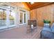 Open porch featuring wood ceiling, wooden bar with sink, brick walls, and wicker furniture at 4022 Newhaven Ne Cir, Brookhaven, GA 30319