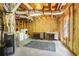 Unfinished basement featuring exposed rafters, insulation, laundry hookups, work tables and concrete flooring at 1926 Regency Cove Ct, Atlanta, GA 30341