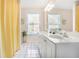 Bright bathroom featuring a double vanity, tiled floor, and ample counter space at 1926 Regency Cove Ct, Atlanta, GA 30341