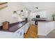 Modern kitchen with white cabinets, a contrasting countertop, hardwood flooring, and bar stool seating at 1926 Regency Cove Ct, Atlanta, GA 30341