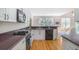 Well-lit kitchen featuring white cabinets, contrasting countertops, stainless steel appliances, and hardwood flooring at 1926 Regency Cove Ct, Atlanta, GA 30341