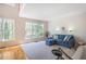 Sunlit living room with large windows, hardwood floors, neutral carpeting, and comfortable blue seating at 1926 Regency Cove Ct, Atlanta, GA 30341