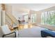 Spacious living room with hardwood floors, bright windows, and adjacent dining area with modern lighting fixtures at 1926 Regency Cove Ct, Atlanta, GA 30341