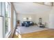 Bright living room with hardwood leading to carpet, large windows offering natural light, and blue sofa seating at 1926 Regency Cove Ct, Atlanta, GA 30341