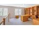 Home office space with built-in bookshelves and a large desk at 1926 Regency Cove Ct, Atlanta, GA 30341
