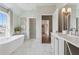 Bright bathroom with soaking tub, walk-in shower, and double sink vanity at 204 N Esplanade, Alpharetta, GA 30009