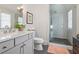 Bright bathroom features a glass shower, gray vanity, and stylish decor at 204 N Esplanade, Alpharetta, GA 30009