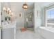 Spa-like bathroom with double vanity, glass shower, and a standalone soaking tub at 204 N Esplanade, Alpharetta, GA 30009