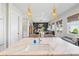 Kitchen island view with marble counters, modern faucet, and open floor plan to the living area at 204 N Esplanade, Alpharetta, GA 30009