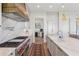 Spacious kitchen features a professional range, pot filler, marble backsplash, and island sink at 204 N Esplanade, Alpharetta, GA 30009