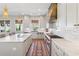 Bright, open kitchen featuring marble countertops, stainless steel appliances, and stylish lighting at 204 N Esplanade, Alpharetta, GA 30009
