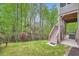 Beautiful backyard with a hillside view, green grass, and a wooden staircase to the deck at 317 Water Oak Ln, Canton, GA 30114