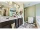 Bathroom featuring double sinks, dark wood cabinets, tile floors, and a glass-enclosed shower at 317 Water Oak Ln, Canton, GA 30114