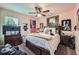 Cozy bedroom featuring a ceiling fan, natural light from the window, and a comfortable bed at 317 Water Oak Ln, Canton, GA 30114