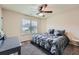 Bright bedroom showcasing a ceiling fan, a large window, and a comfortable bed with gray bedding at 317 Water Oak Ln, Canton, GA 30114